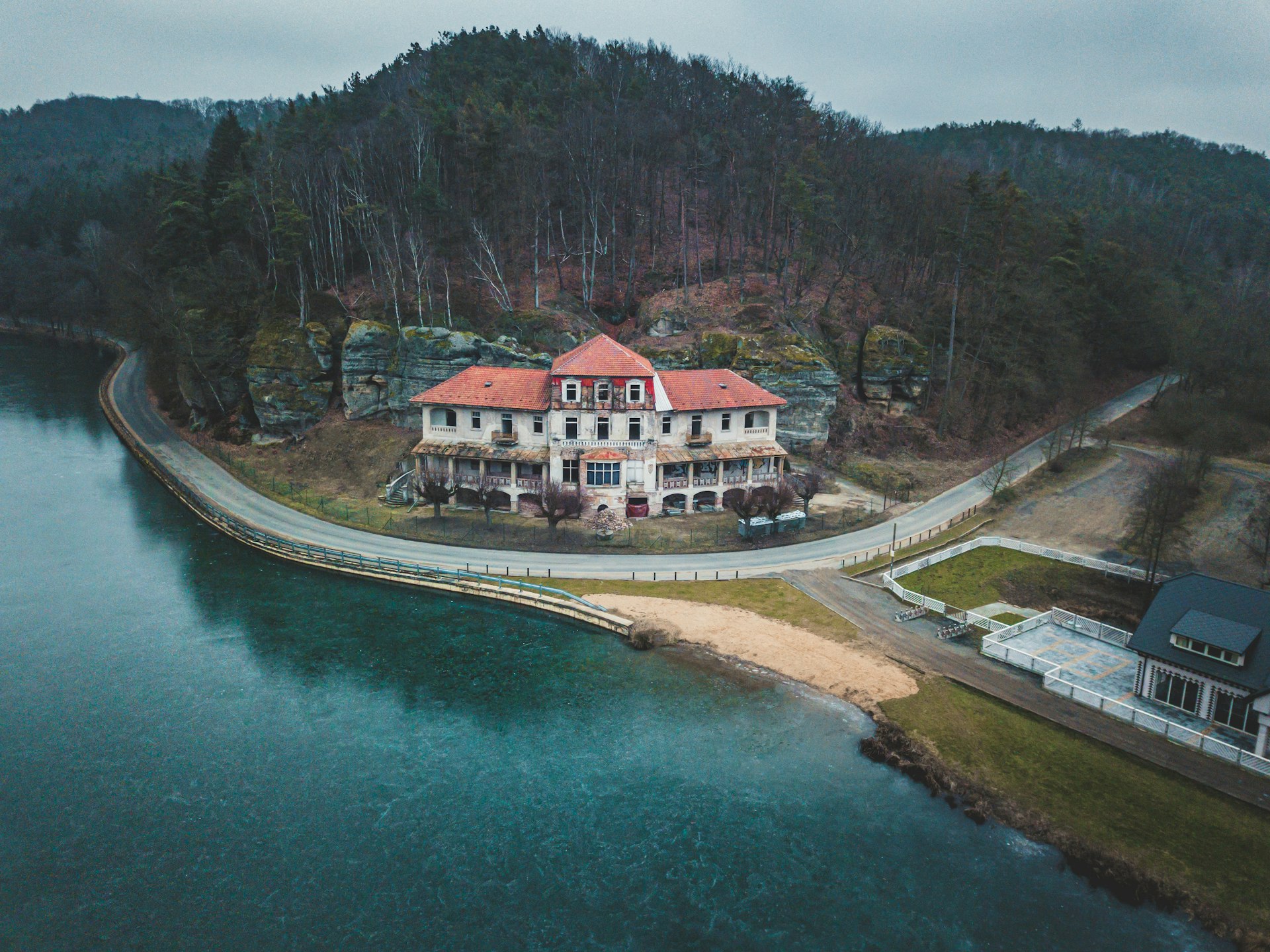 white and brown house near river