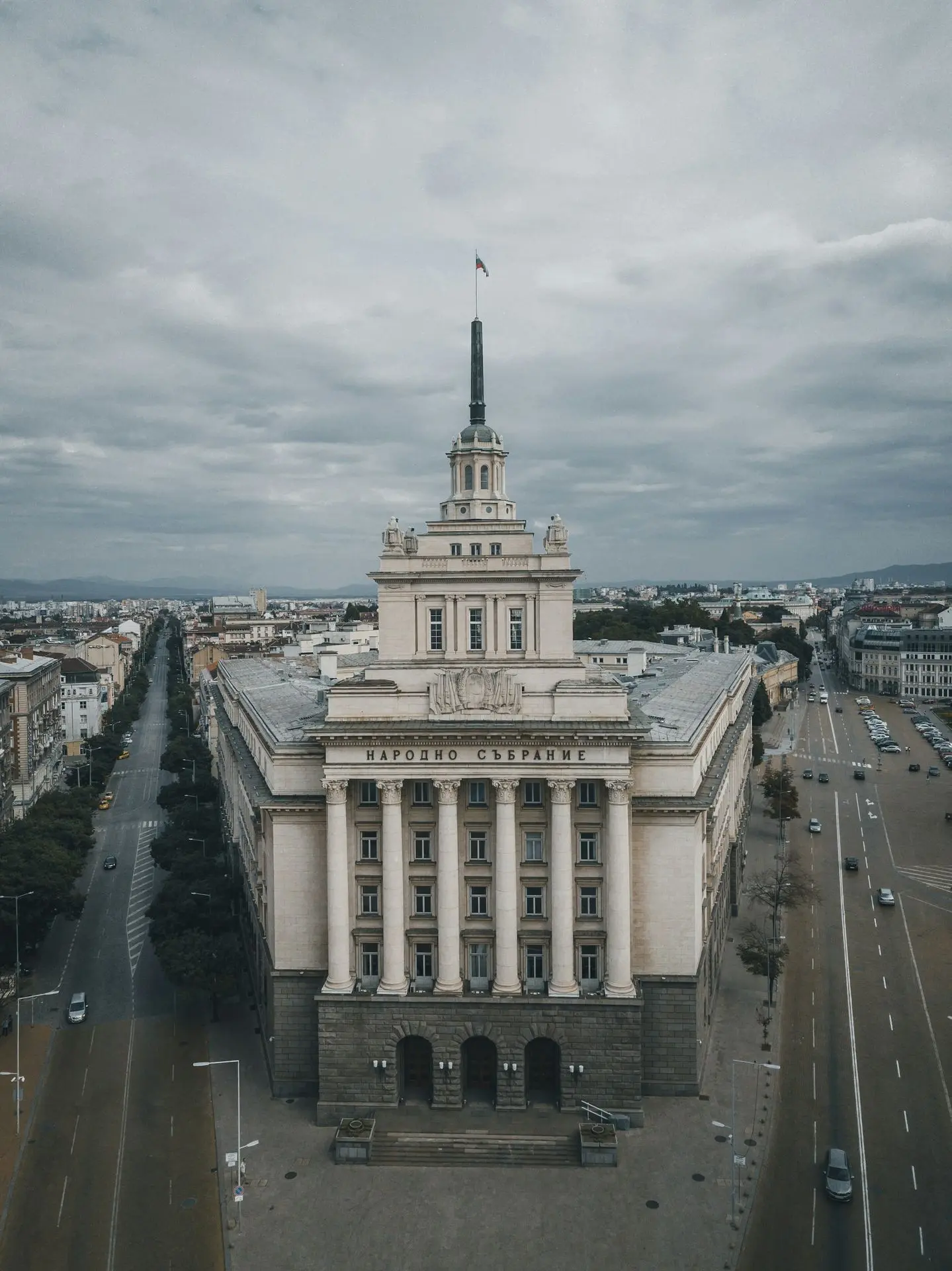 white and gray concrete building under cloudy sky